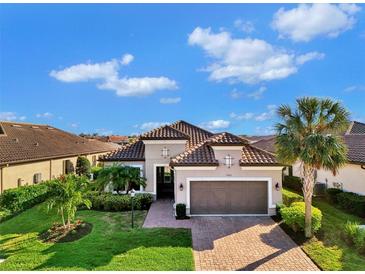 Single-story home with tile roof, 2-car garage, and landscaped yard at 5401 Manchini St, Sarasota, FL 34238