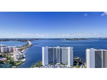 Aerial view of waterfront property with expansive bay and bridge views at 555 Quay Cmn # Ph2002, Sarasota, FL 34236
