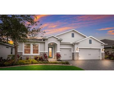 Attractive two-story house with stone accents and landscaped lawn at 5817 Hevena Ct, Palmetto, FL 34221