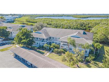 Aerial view of condo building with water access and lush landscaping at 610 Estuary Dr # 610, Bradenton, FL 34209