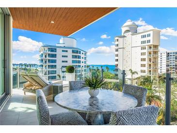 Spacious balcony with outdoor furniture and city views at 111 Golden Gate Pt # 401, Sarasota, FL 34236