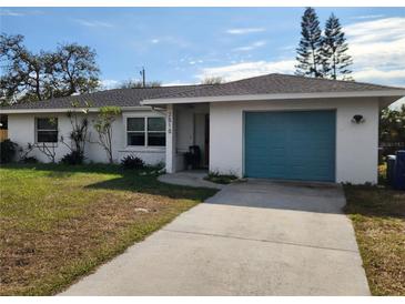 Ranch-style home with teal garage door and landscaped lawn at 2510 Parma St, Sarasota, FL 34231