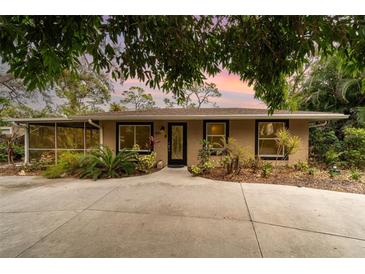 Cute updated bungalow, featuring a large driveway and lush landscaping at 2885 Arrowhead Rd, Venice, FL 34293