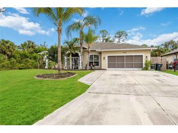 Single-story house with palm trees, landscaped lawn, and a large driveway at 3506 Culpepper Ter, North Port, FL 34286