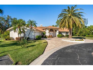 Beautiful one-story home with palm trees and a paved driveway at 4512 Spring Flower Ct, Sarasota, FL 34233