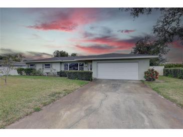 Single-story home with a white garage door and landscaped lawn at 5117 6Th Avenue W Dr, Bradenton, FL 34209