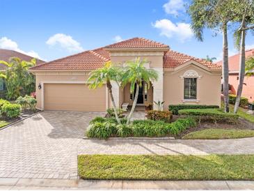 Attractive single-story home with a tile roof and landscaped front yard at 5133 Cantabria Crst, Sarasota, FL 34238