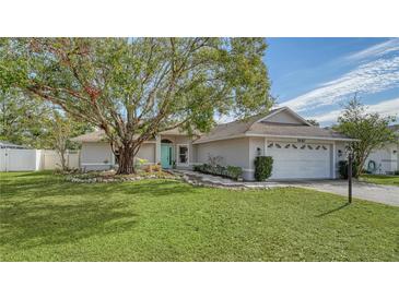 Charming single-story home with landscaped lawn and a teal front door at 5687 Milton Ave, Sarasota, FL 34243