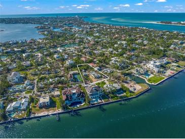 Aerial view of waterfront property with large lot and tennis court at 624 Norsota Way, Sarasota, FL 34242