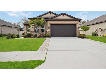 Attractive one-story home with a two-car garage and landscaped lawn at 715 116Th Ne Ct, Bradenton, FL 34212