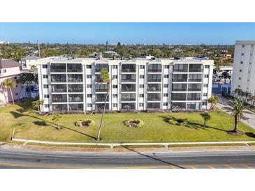 Building's exterior, showcasing landscaping and ocean views at 757 Beach Rd # 208, Sarasota, FL 34242