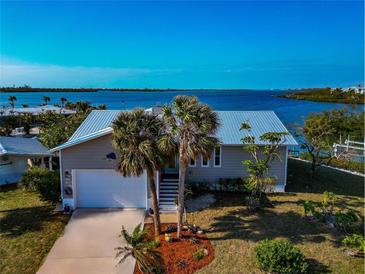 Single-Gathering home with waterfront access and lush landscaping at 10428 Marion St, Englewood, FL 34224