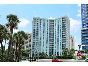 High rise building with water views and palm trees at 1111 N Gulfstream Ave # 14C, Sarasota, FL 34236