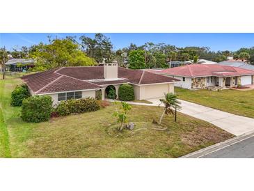 Single-story home with red tile roof and a large driveway at 121 Van Dyck Dr # Dr, Nokomis, FL 34275