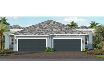 Two-car garage, light blue exterior, gray roof, and landscaped yard at 12649 Palatka Dr, Venice, FL 34293