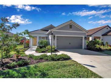 Gray house with two-car garage and landscaping at 12915 True Blue Cir, Bradenton, FL 34211