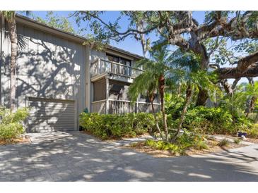 Two-story home with attached garage and lush landscaping at 1423 Landings Pl # 59, Sarasota, FL 34231