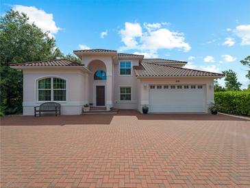 Two-story house with brick driveway and tile roof at 1981 Bayshore Dr, Englewood, FL 34223