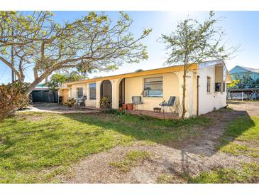 Charming single story home with a spacious front yard and covered porch at 315 Palm Grove Ave, Englewood, FL 34223