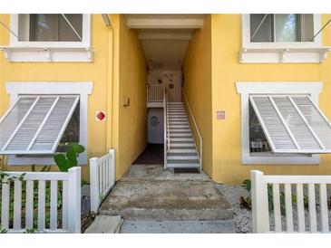 Inviting yellow building exterior with white accents and stairs at 3640 41St S Ln # F, St Petersburg, FL 33711