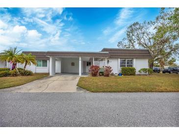 White exterior condo with carport and landscaping at 3904 Lakeside Rd # 174, Sarasota, FL 34232