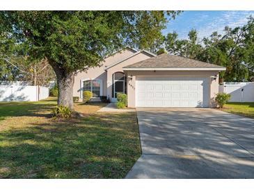 House exterior featuring a two-car garage and well-maintained lawn at 4927 69Th E Ct, Palmetto, FL 34221