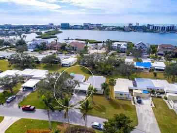 Aerial view of a waterfront home community, showcasing the subject property and its surroundings at 5826 Driftwood Pl # 34, Sarasota, FL 34231