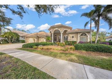 Beautiful home with landscaped yard, driveway, and three-car garage at 5826 Driftwood Pl # 34, Sarasota, FL 34231