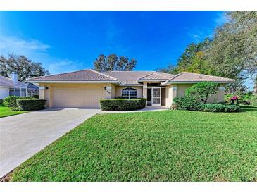 Single-story house with attached garage and well-maintained lawn at 601 Lakescene Dr, Venice, FL 34293