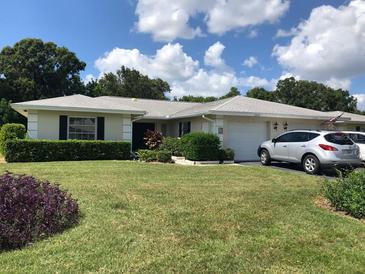 Single-story home with a well-maintained lawn and attached garage at 7092 W Country Club N Dr, Sarasota, FL 34243