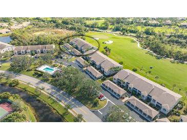 Aerial view of condo community with pool, golf course, and tennis court at 9621 Castle Point Dr # 1024, Sarasota, FL 34238