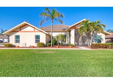 Single-story home with landscaped lawn and palm trees at 1144 Hoover St, Nokomis, FL 34275