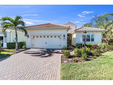 Beautiful one-story home with a tile roof, landscaped yard, and two-car garage at 11816 Altamonte Ct, Venice, FL 34293