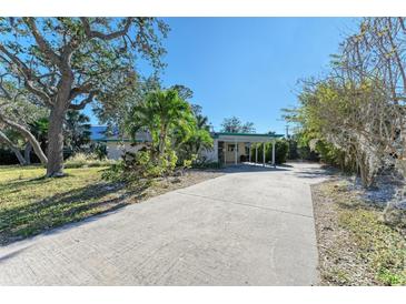 Ranch home with carport & mature landscaping at 1220 De Narvaez Ave, Bradenton, FL 34209