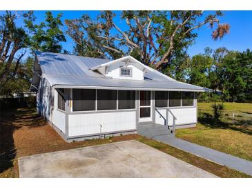 Charming bungalow with metal roof, screened porch, and spacious yard at 1717 32Nd St, Sarasota, FL 34234