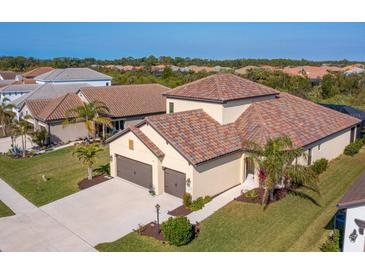 Aerial view of a single-Gathering home with a two-car garage and tile roof at 1748 Still River Dr, Venice, FL 34293