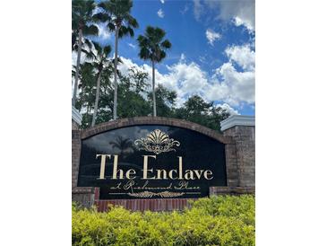 The Enclave at Richmond Place entrance sign, featuring a brick and granite design at 18001 Richmond Place Dr # 1222, Tampa, FL 33647