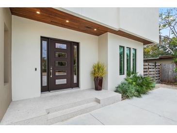 Modern front door with glass panels and stone steps leading to the entrance at 2138 Floyd St, Sarasota, FL 34239