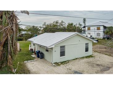 Quaint light green house with metal roof and small yard at 29 Mound, Terra Ceia, FL 34250