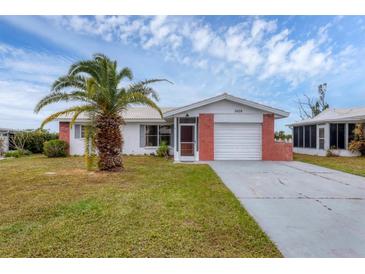 Single story home with brick garage and palm tree at 3608 Joyce Dr, Bradenton, FL 34208