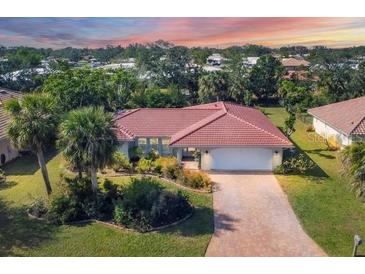 Attractive single-story home with a large yard and a paved driveway at 395 W Rossetti Dr, Nokomis, FL 34275