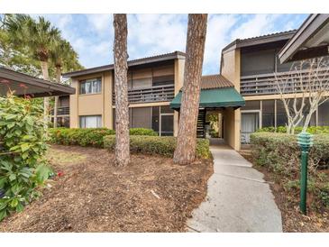 Condo building exterior with walkway, landscaping, and parking at 5671 Ashton Lake Dr # 3, Sarasota, FL 34231