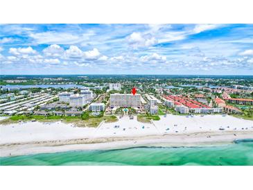 Aerial view of beachfront condo building with pool and ocean views at 6140 Midnight Pass Rd # 902, Sarasota, FL 34242