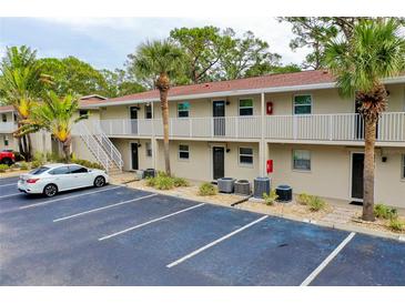 Two-story condo building with parking and tropical landscaping at 972 La Costa Cir # 5, Sarasota, FL 34237