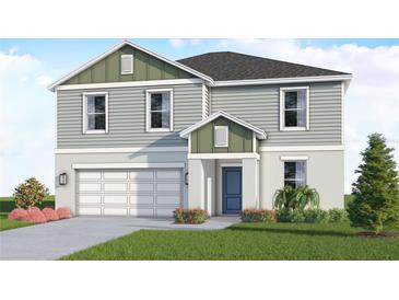 Two-story house with green and gray siding, two-car garage, and landscaping at 4523 Boxelder Avenue, Parrish, FL 34219