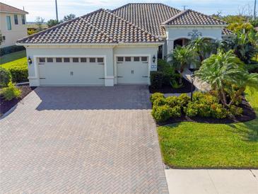 Exterior of a single-Gathering home with a three-car garage and landscaped yard at 7817 Passionflower Dr, Sarasota, FL 34241