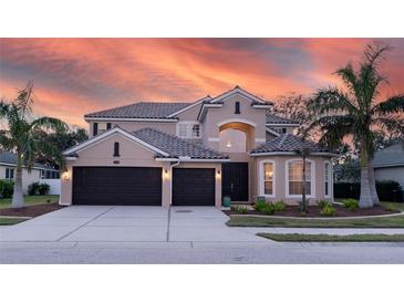 Two-story house with a two-car garage, landscaped yard, and brick facade at 1178 Fraser Pine Blvd, Sarasota, FL 34240