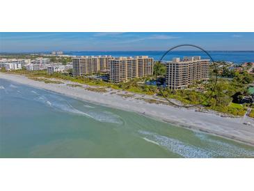 Aerial view of beachfront condo building with tennis courts and pool at 1211 Gulf Of Mexico Dr # 603, Longboat Key, FL 34228