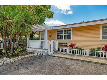 Inviting exterior with a charming porch and well-maintained landscaping at 1603 Gulf N Dr # 24, Bradenton Beach, FL 34217