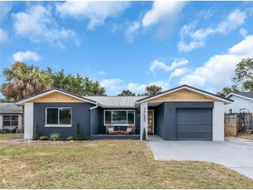 Newly renovated home with modern facade, landscaped lawn, and driveway at 1725 Solon Ave, Dunedin, FL 34698